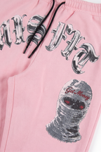 Cairo sweatpants detail showing the Get Money ski mask graphic and Sinner's Club script down the leg