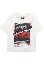 Cahuenga off-white oversized graphic tee with a torn palm collage against a red sky and Los Angeles graffiti script