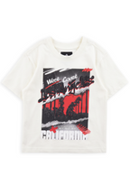 Cahuenga off-white oversized graphic tee with a torn palm collage against a red sky and Los Angeles graffiti script