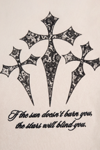 Rafe sweatpants detail showing the three gothic crosses and script print in black on bone fleece