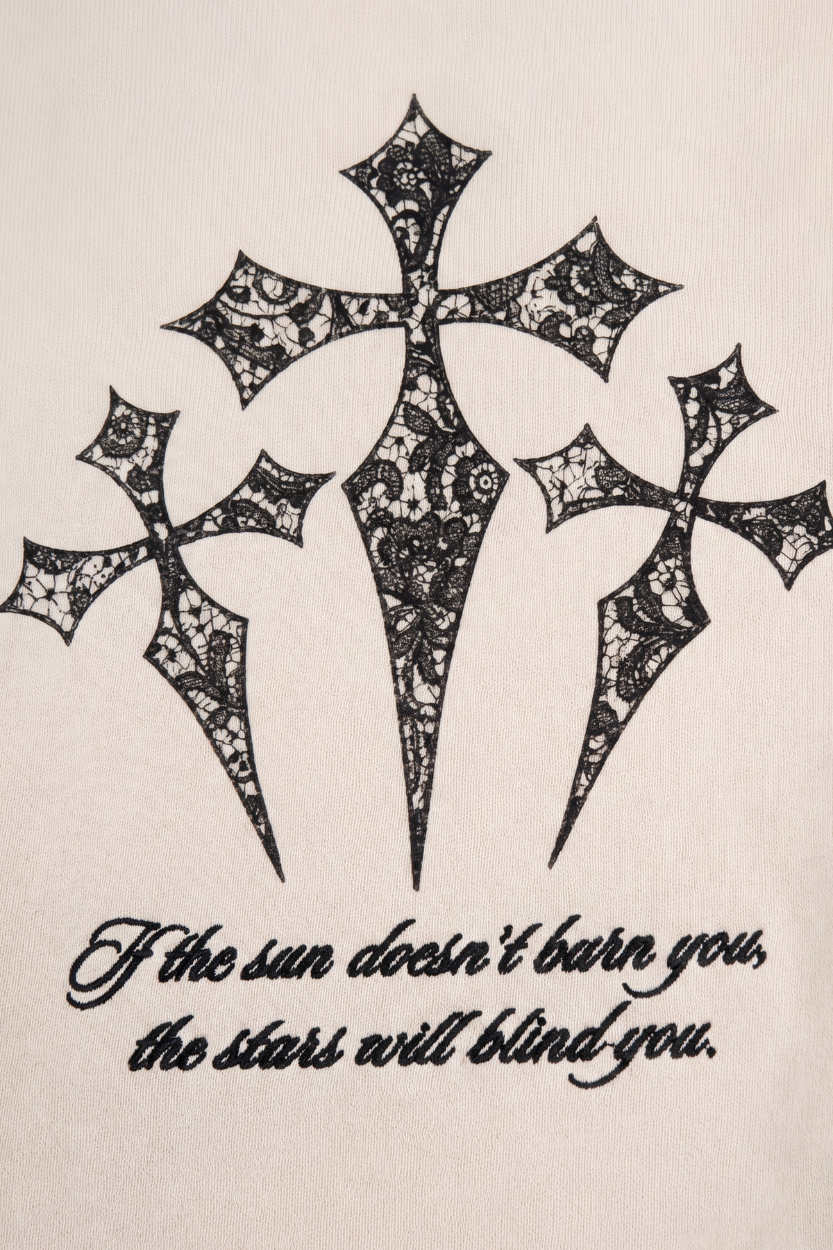 Rafe sweatpants detail showing the three gothic crosses and script print in black on bone fleece